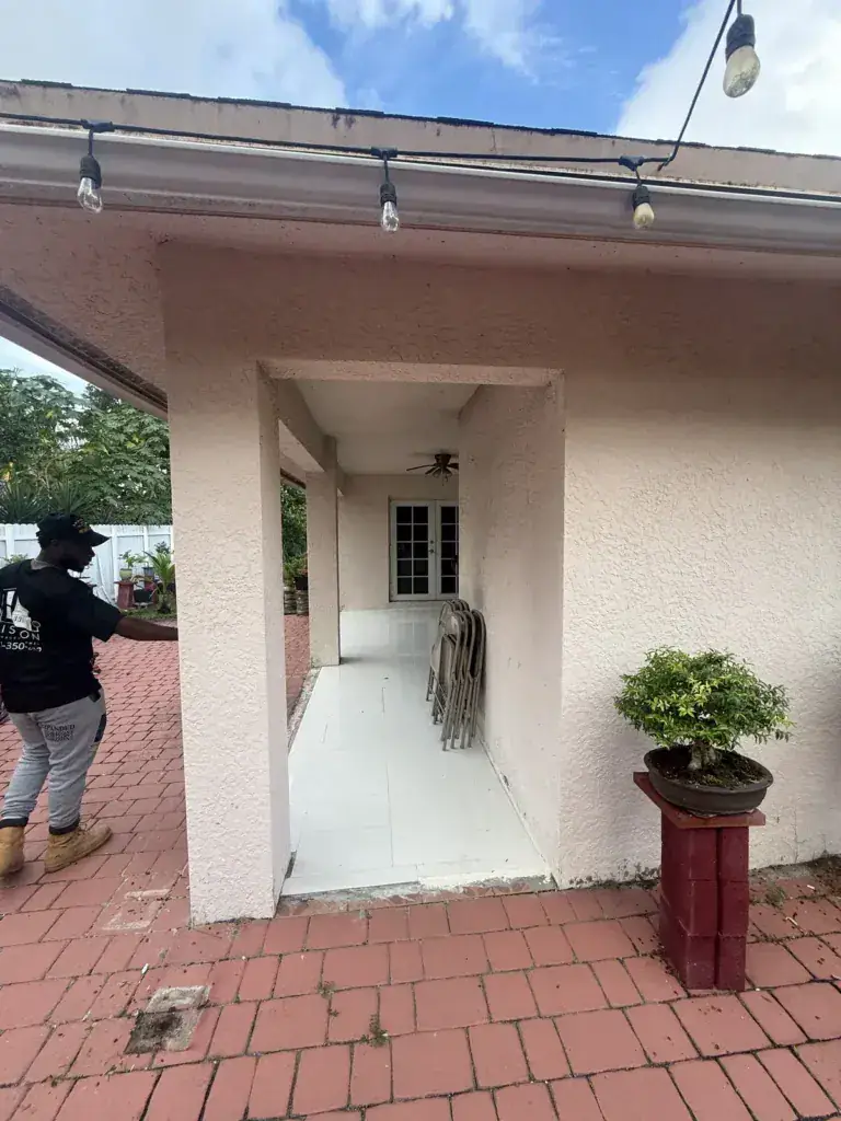 Covered side patio and walkway before the impact glass enclosure
