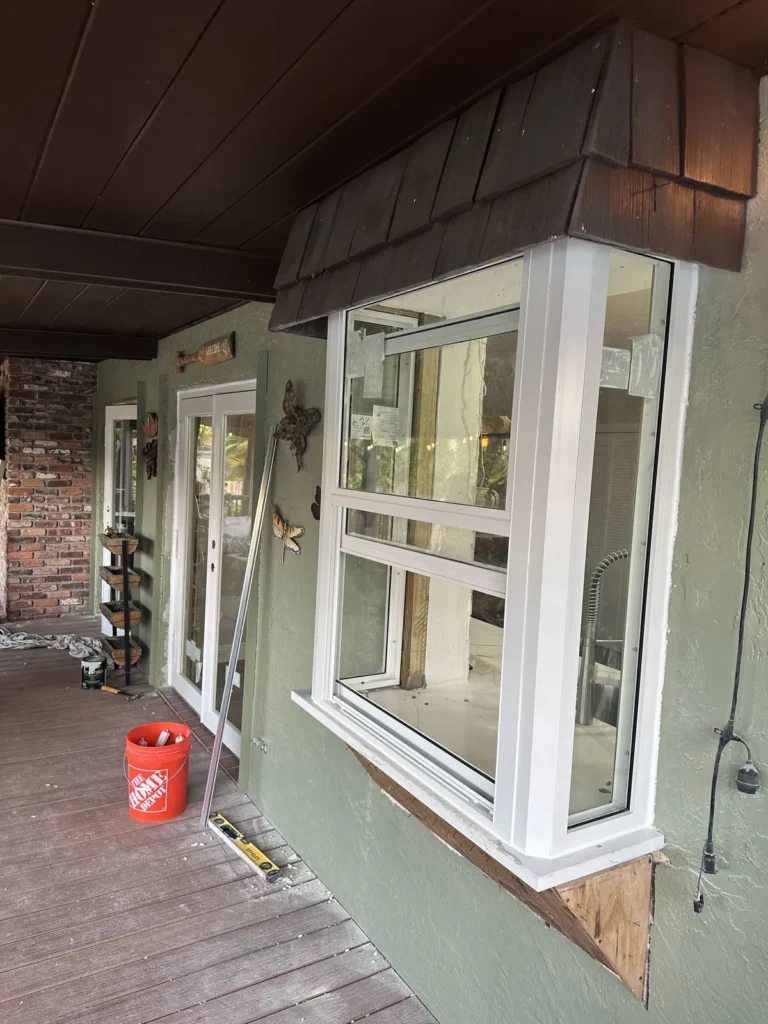 New white impact garden window installed under a covered porch