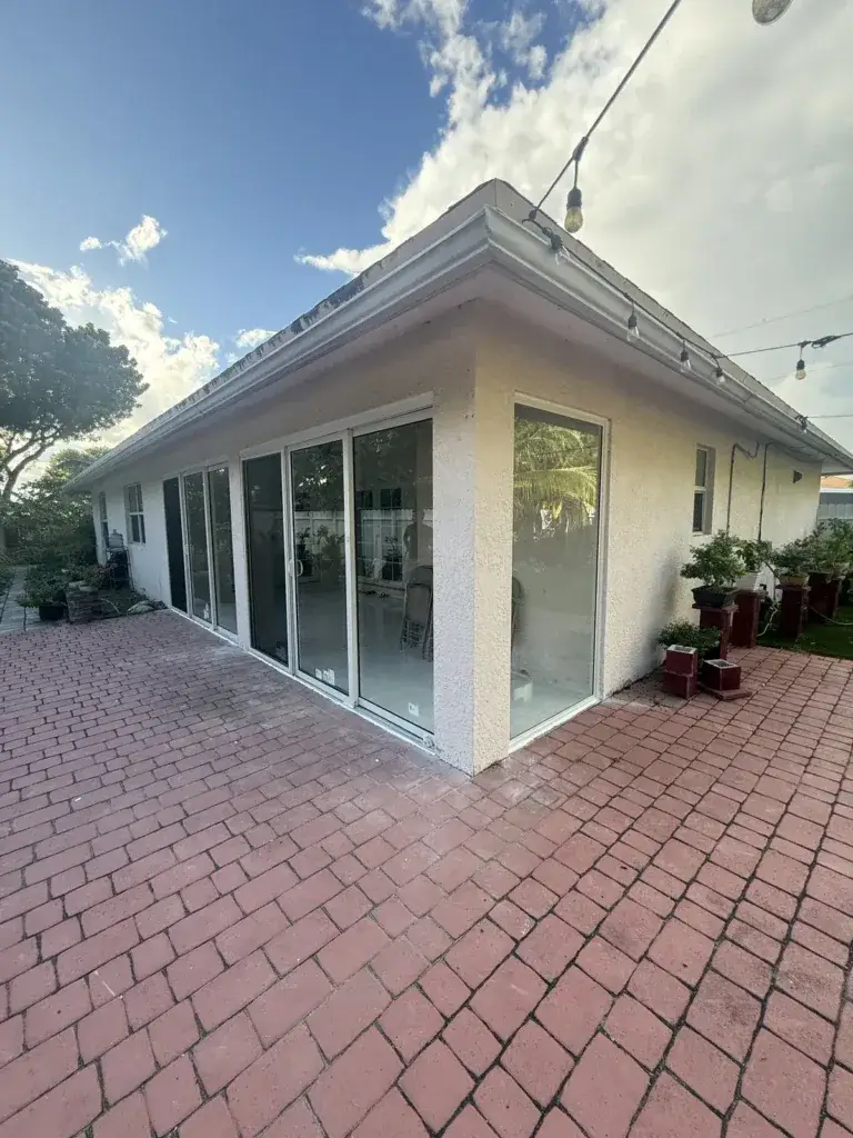 Finished patio enclosure with full-height impact glass on two sides