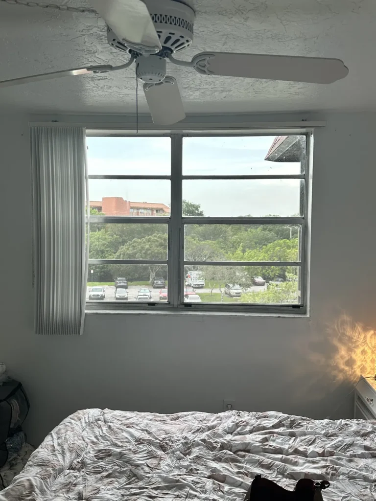 Old bedroom window in Plantation, FL before impact window replacement