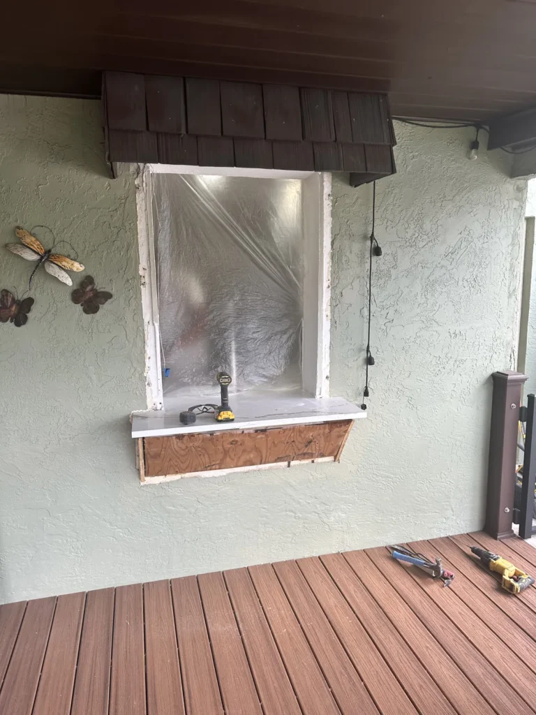 Window opening on a covered porch wrapped and prepared for a new impact window