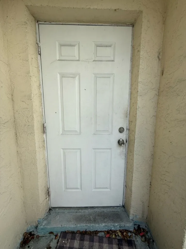 Old six-panel door in Tamarac, FL before replacement