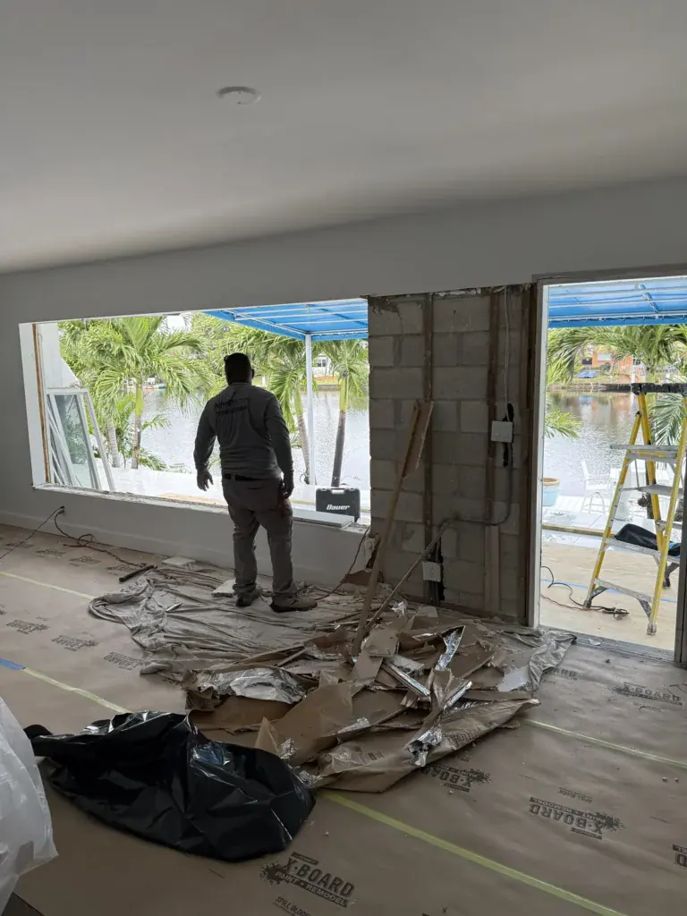 Block wall opened up and prepared for a new impact sliding glass door, canal view behind
